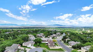 Aerial perspective of suburban area featuring a mountainous background