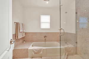 Bathroom with a bath and a shower with shower door