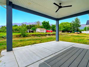 View of patio featuring a ceiling fan and a mountain view