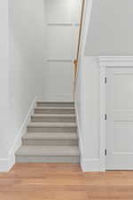 Stairway featuring wood finished floors and baseboards