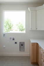 Washroom featuring electric dryer hookup, washer hookup, baseboards, tile patterned flooring, and gas dryer hookup
