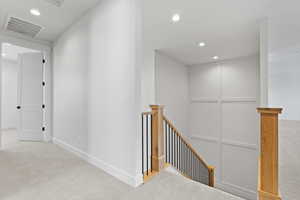 Corridor featuring an upstairs landing, carpet flooring, recessed lighting, and baseboards