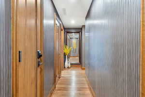 Corridor with wood finished floors and baseboards
