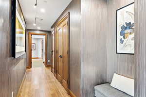 Hall featuring light wood-type flooring and recessed lighting