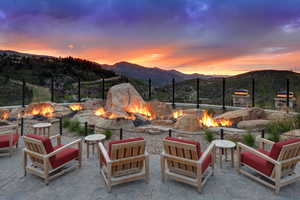 View of patio / terrace with an outdoor fire pit and a mountain view