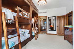 Bedroom with light colored carpet