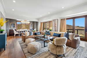 Living room with recessed lighting, light wood finished floors, and crown molding