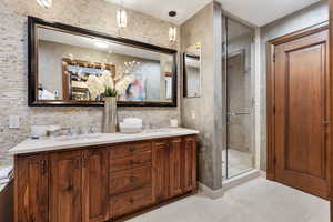 Full bathroom with a shower stall and double vanity