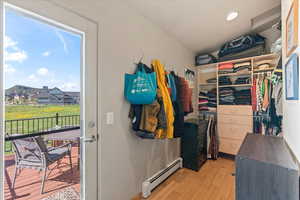 Primary bedroom closet with door to patio/deck