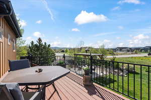 Wooden deck with a mountain view and outdoor dining area