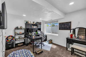Carpeted office with baseboards and recessed lighting