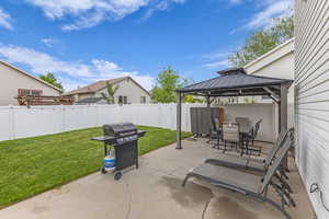 View of patio / terrace with a gazebo, a grill, and outdoor dining space