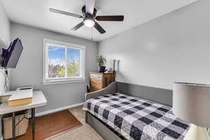 Carpeted bedroom with baseboards and ceiling fan