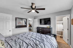 Bedroom with light tile patterned flooring and ceiling fan