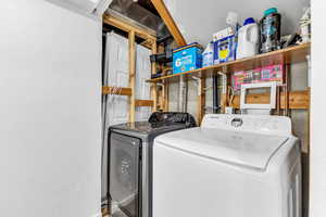 Clothes washing area featuring washer and dryer
