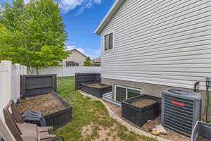 View of yard with a garden and cooling unit