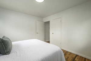 Bedroom with baseboards and wood finished floors