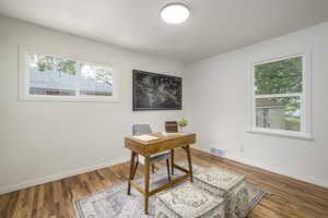 Office area with baseboards and wood finished floors