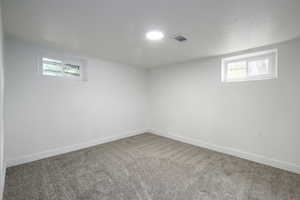Basement with carpet floors and baseboards