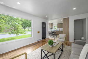 Living area featuring light wood-type flooring, recessed lighting, and baseboards
