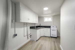 Washroom with light wood-style floors and baseboards