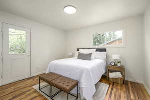Bedroom featuring baseboards and wood finished floors