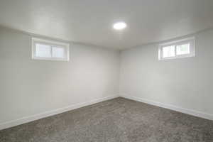 Below grade area featuring baseboards and carpet floors