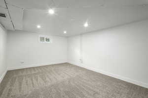 Below grade area with carpet floors, baseboards, and recessed lighting