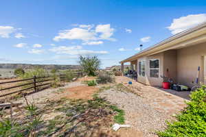 Fenced backyard with a patio