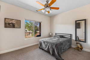 Bedroom featuring carpet, baseboards, and ceiling fan