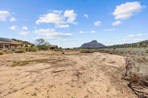 View of yard with fence, a mountain view, and a view of countryside
