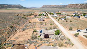 Aerial view of sparsely populated area with mountains and a desert landscape
