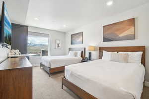 Bedroom featuring light carpet and recessed lighting