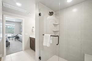 Full bathroom featuring a stall shower, vanity, recessed lighting, and tile patterned floors