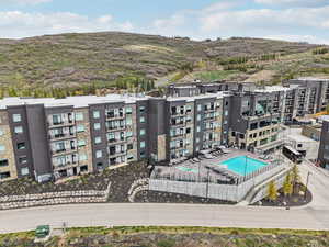 Drone / aerial view of a pool and a mountainous background