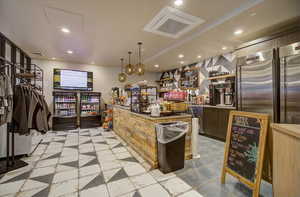 Kitchen with recessed lighting, stainless steel built in refrigerator, and decorative light fixtures
