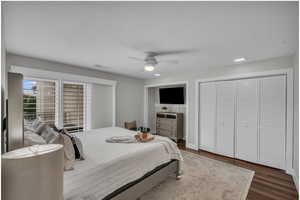Bedroom featuring wood finished floors, a textured ceiling, and ceiling fan