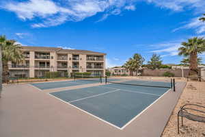 View of tennis court with community basketball court
