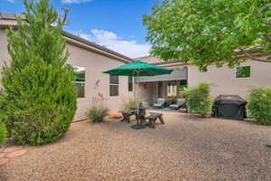 Rear view of house featuring stucco siding and a patio