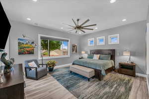 Bedroom featuring baseboards, wood finished floors, recessed lighting, and ceiling fan