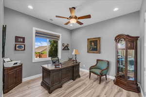 Home office with a ceiling fan, light wood finished floors, baseboards, and recessed lighting