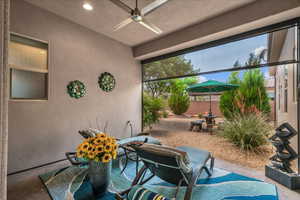 View of patio featuring ceiling fan and fence