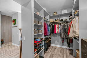 Walk in closet featuring wood finished floors