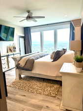 Bedroom featuring light wood-style flooring, ceiling fan, and a textured ceiling