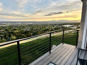 Balcony at dusk featuring a mountain view