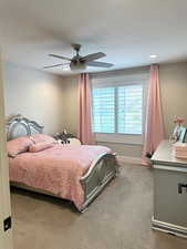 Bedroom with light colored carpet, a ceiling fan, baseboards, recessed lighting, and a textured ceiling