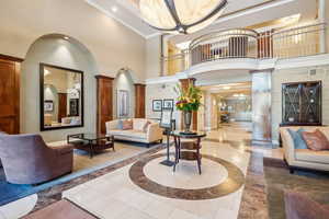 Lobby featuring a towering ceiling, ornamental molding, and recessed lighting