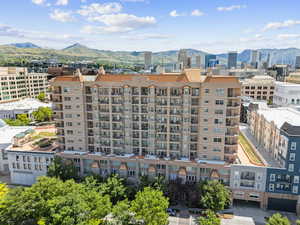 View of urban area featuring a mountain backdrop and apartment complex