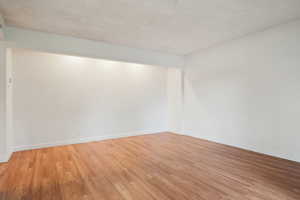 Unfurnished room with light wood-style floors and baseboards