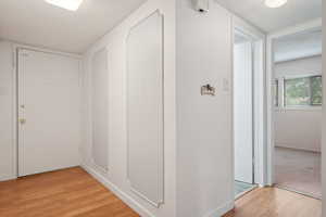 Hallway featuring a textured ceiling and light wood-type flooring